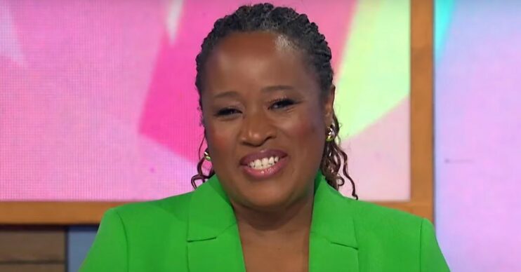 Loose Women star Charlene White smiling at camera in a green jacket
