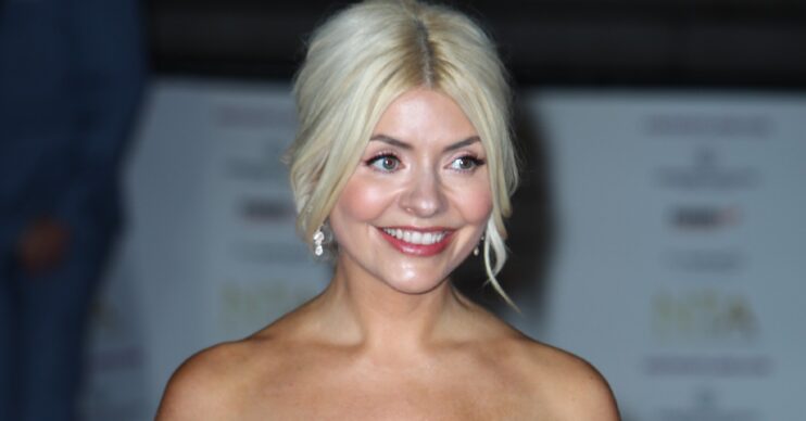 Holly Willoughby smilign in a black dress